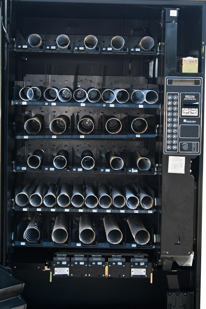 A picture of an old black vending machine